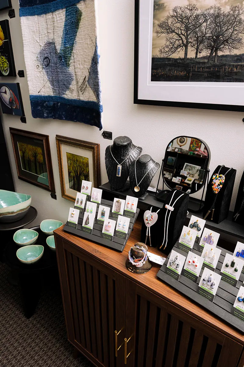 Jewelry, ceramics, fiber wall art, photography prints and handmade gifts displayed at Madison Art Market in Madison, Wisconsin.