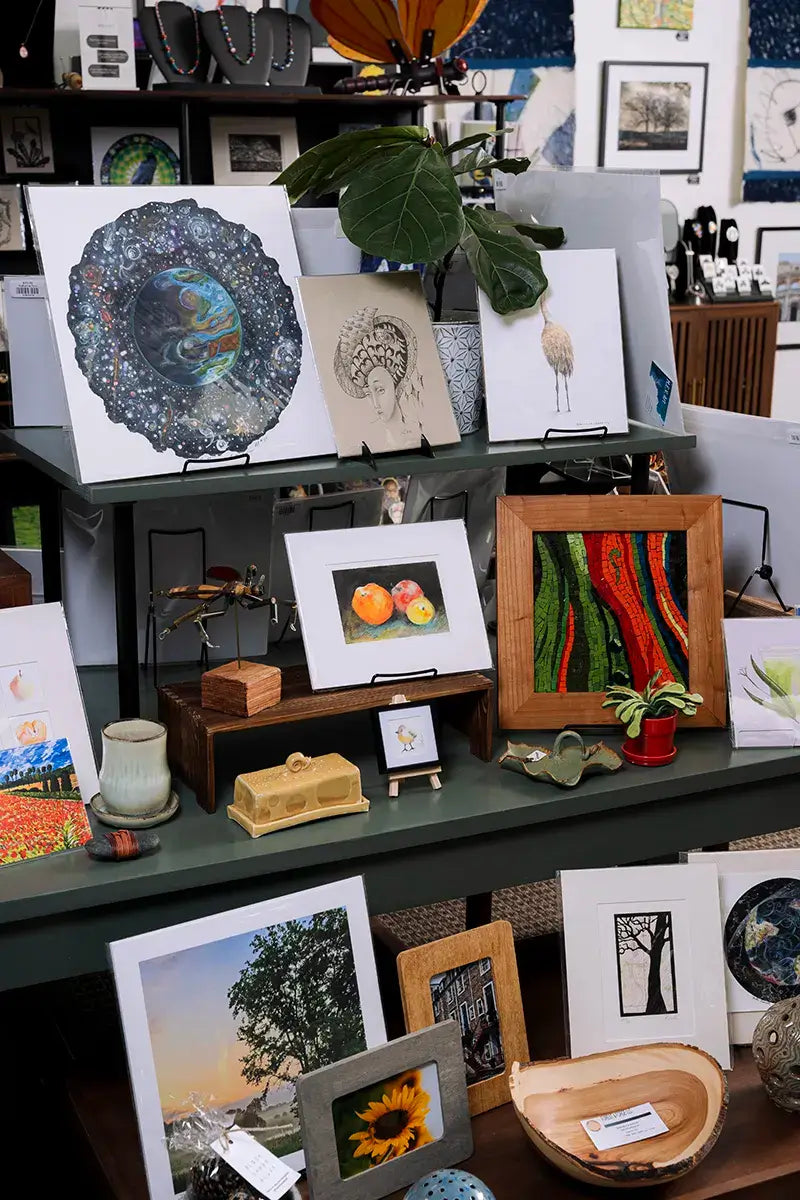 Art prints and small handmade gifts on a display table at Madison Art Market in Madison, Wisconsin.